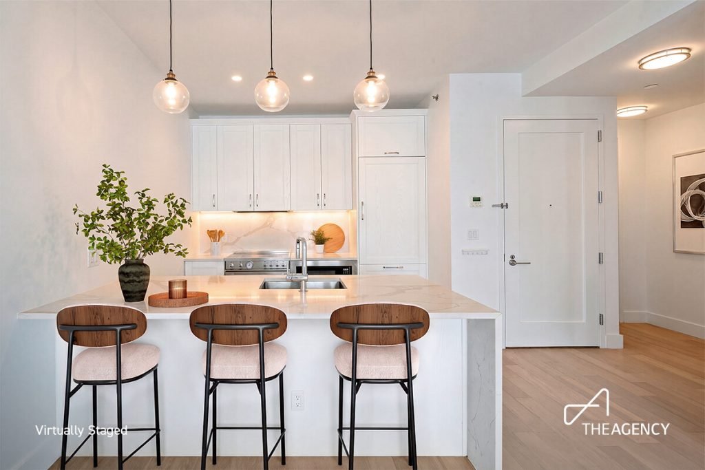 Kitchen with an island and three bar stools at 21-19 46th Ave, Unit 4