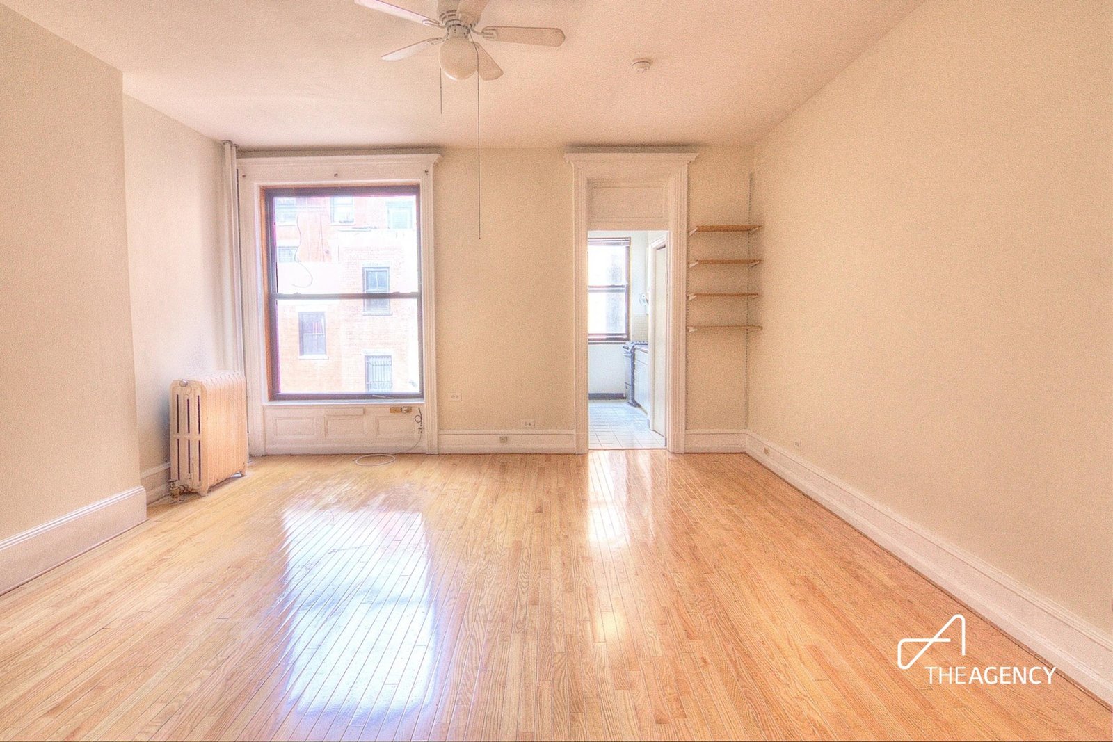Empty room with hardwood flooring and a ceiling fan at 259 W 90th Street 3-R