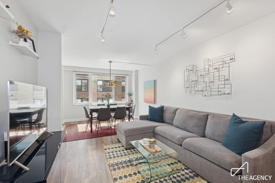 Living and dining room with track lighting at 301 E 22nd Street 12H